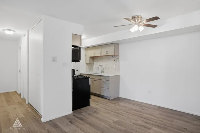 a kitchen with a refrigerator and a sink