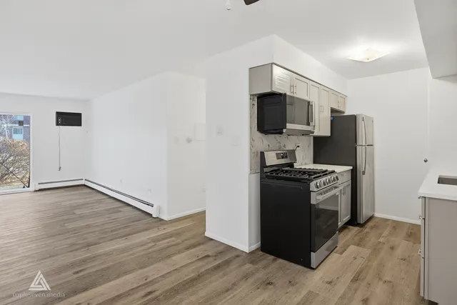 a kitchen with granite countertop a refrigerator and a stove