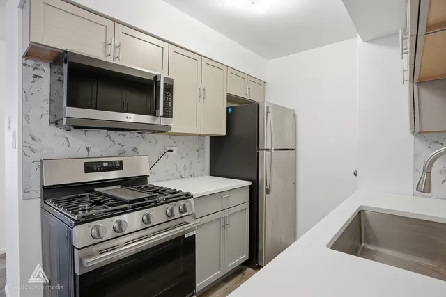 a kitchen with a stove microwave and refrigerator