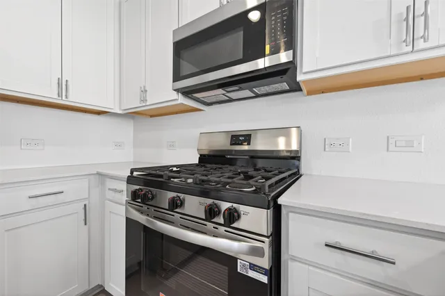 a stove top oven sitting inside of a kitchen