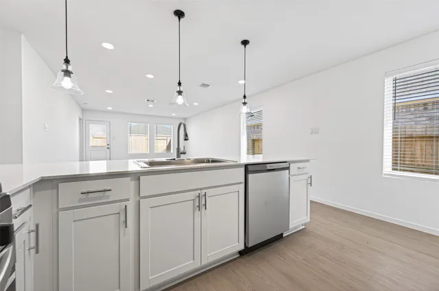 a view of a kitchen with center island and wooden floor