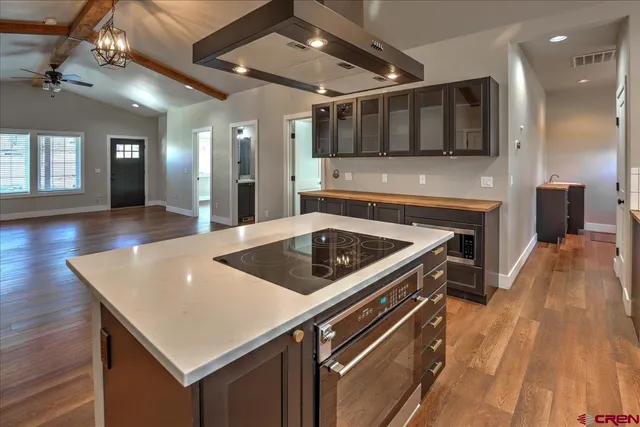 a kitchen with a stove a sink and a microwave