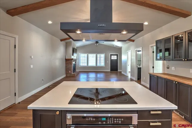 a large kitchen with stainless steel appliances granite countertop a stove and a sink
