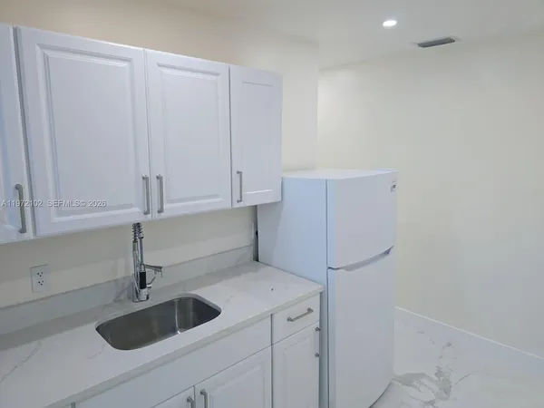 a kitchen with a sink and cabinets