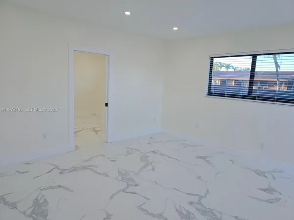 an empty room with white walls