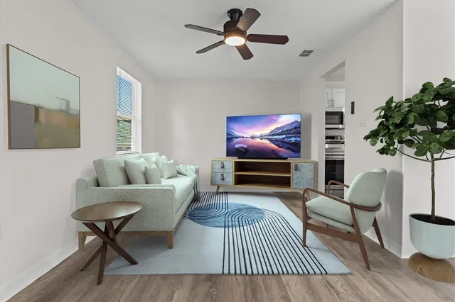a living room with furniture and a potted plant