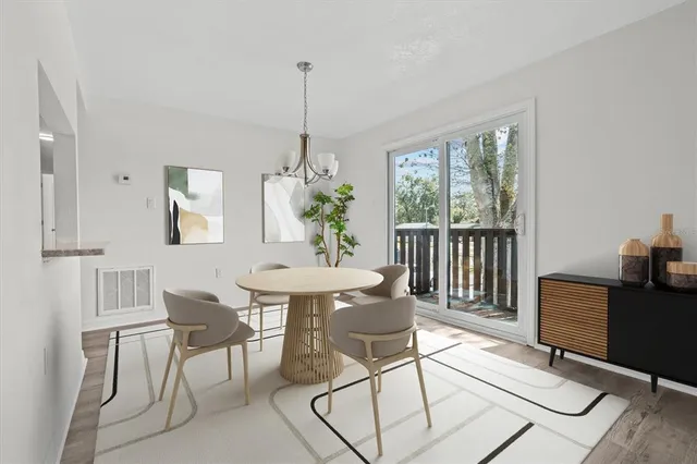 a view of a dining room with furniture window and wooden floor