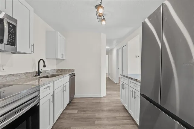 a kitchen with a sink and refrigerator
