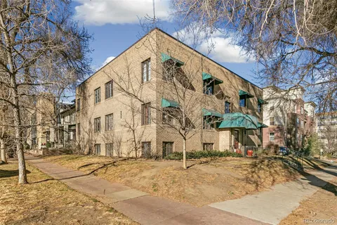 a view of a building with snow on the road