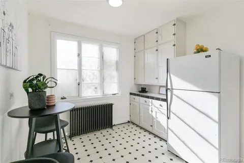 a kitchen with granite countertop a appliances and a sink