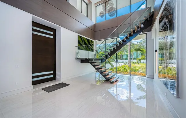 a living room with furniture a bookshelf and a flat screen tv