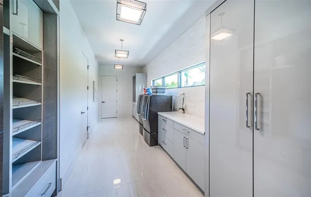 a view of a patio with table and chairs potted plants and large tree