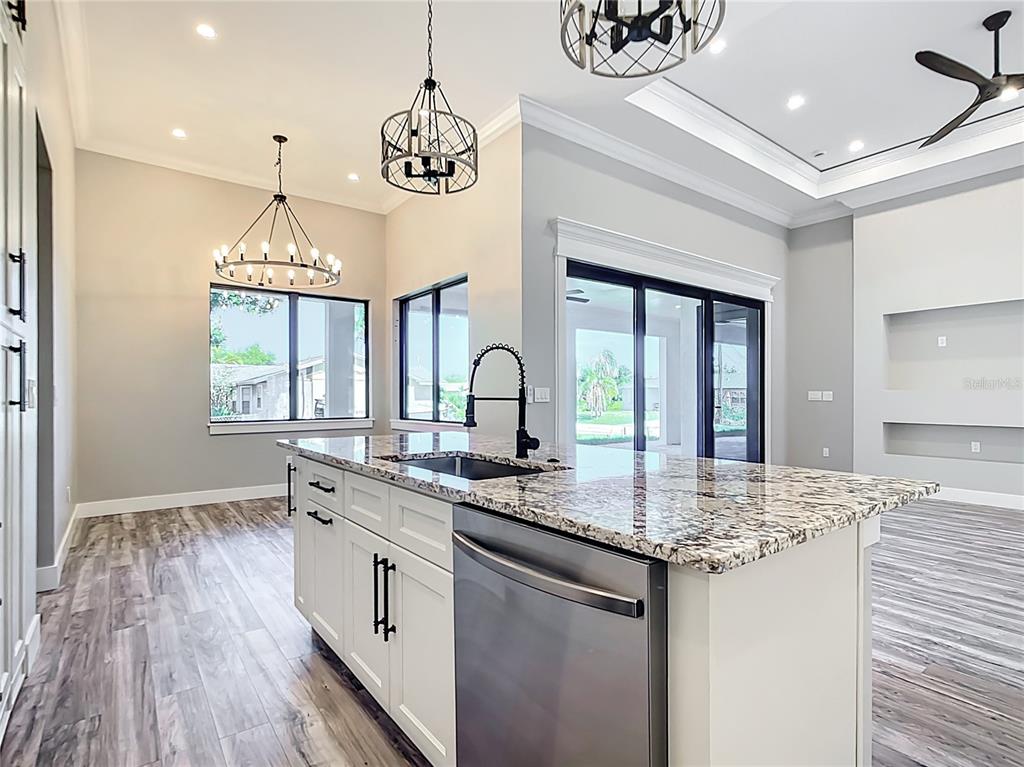 10588 Kidron Avenue Englewood, FL 34224 - Photo 11 of 53 a kitchen with granite countertop stainless steel appliances a sink and stove