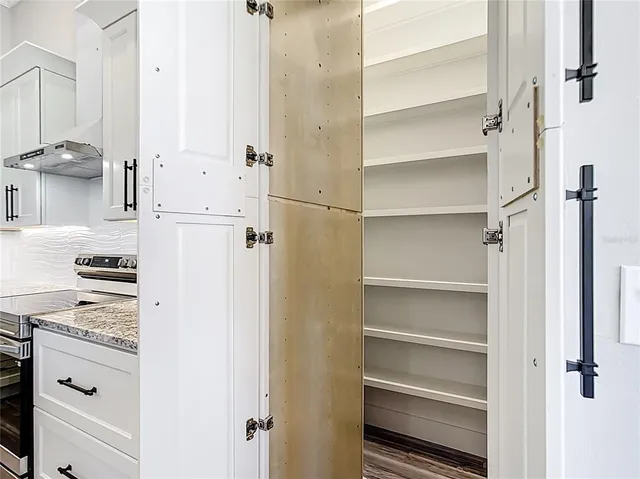 a view of kitchen with white cabinets and white appliances