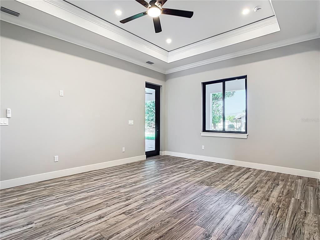 10588 Kidron Avenue Englewood, FL 34224 - Photo 18 of 53 a view of an empty room with window and wooden floor
