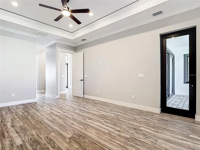 a view of an empty room and wooden floor
