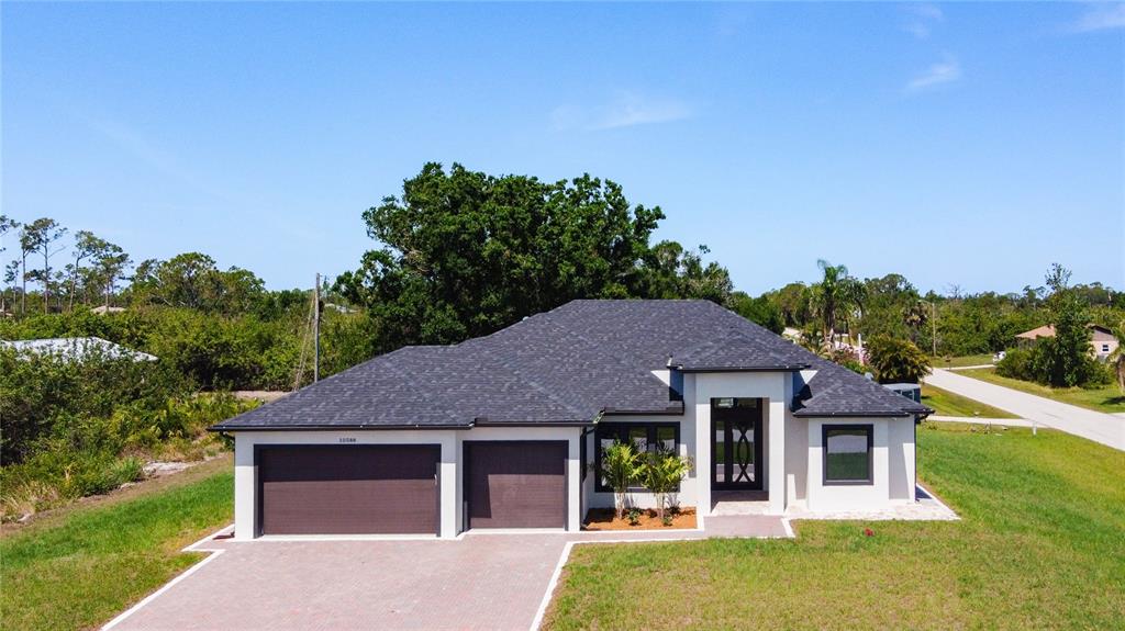 10588 Kidron Avenue Englewood, FL 34224 - Photo 2 of 53 a front view of a house with garden
