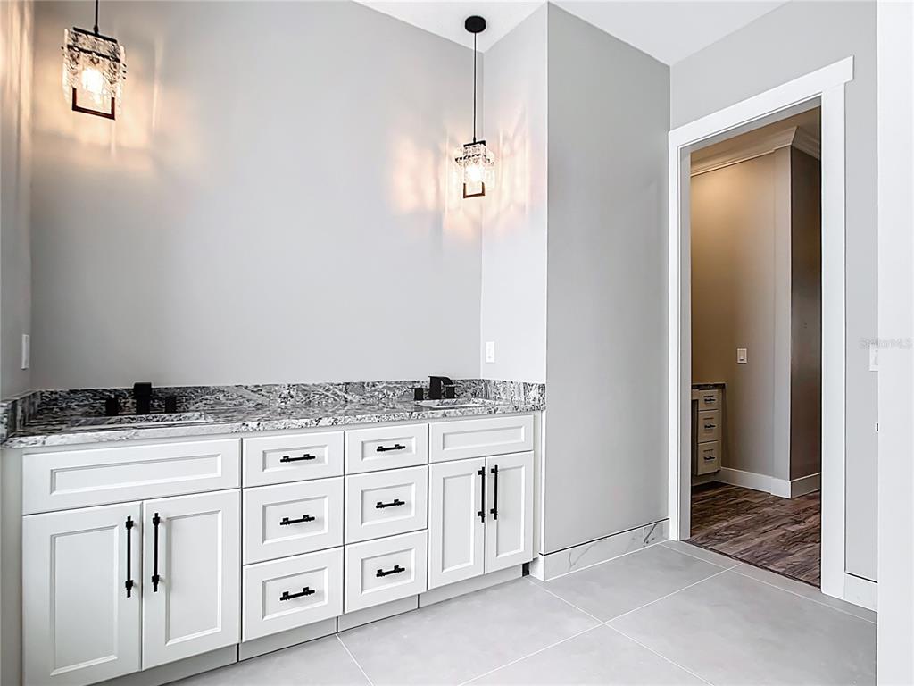 10588 Kidron Avenue Englewood, FL 34224 - Photo 25 of 53 a kitchen with white cabinets and appliances