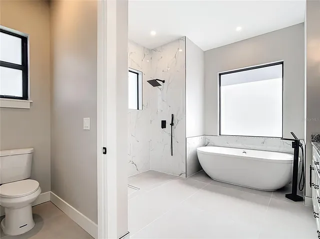 a bathroom with a white bath tub sitting shower