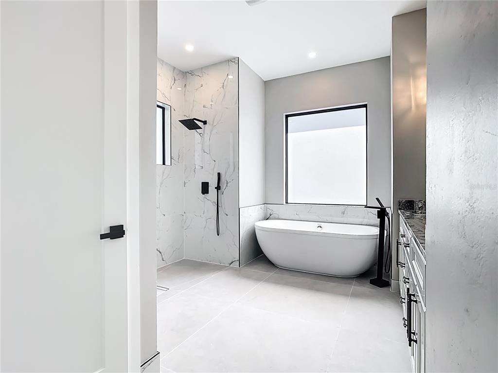 10588 Kidron Avenue Englewood, FL 34224 - Photo 28 of 53 a bathroom with a bathtub and shower