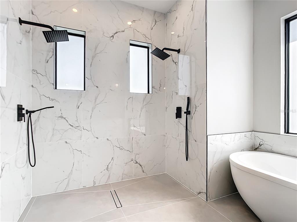 10588 Kidron Avenue Englewood, FL 34224 - Photo 29 of 53 a bathroom with a white bath tub sitting shower