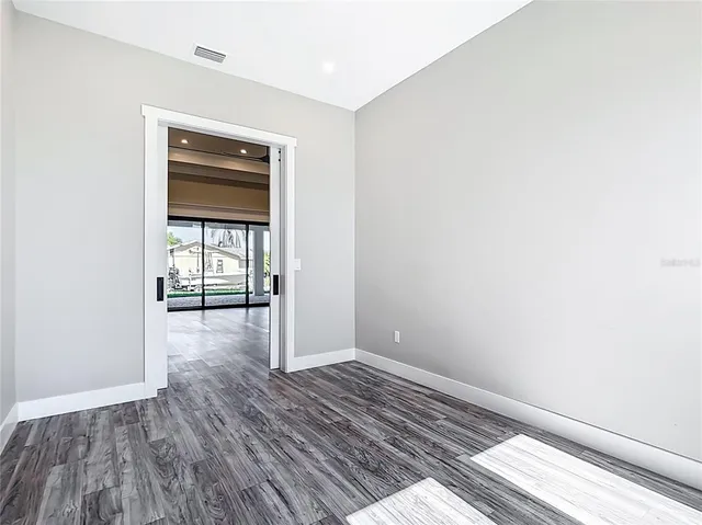 a view of a hallway with wooden floor
