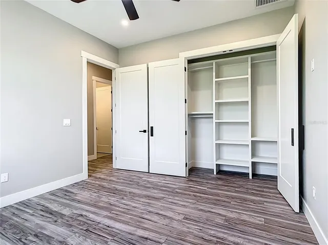 a bathroom with a granite countertop toilet sink and mirror