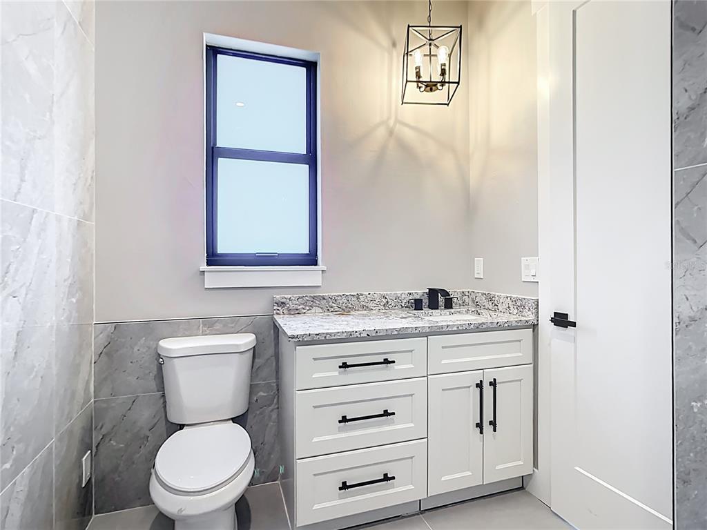 10588 Kidron Avenue Englewood, FL 34224 - Photo 39 of 53 a bathroom with a granite countertop toilet sink and mirror