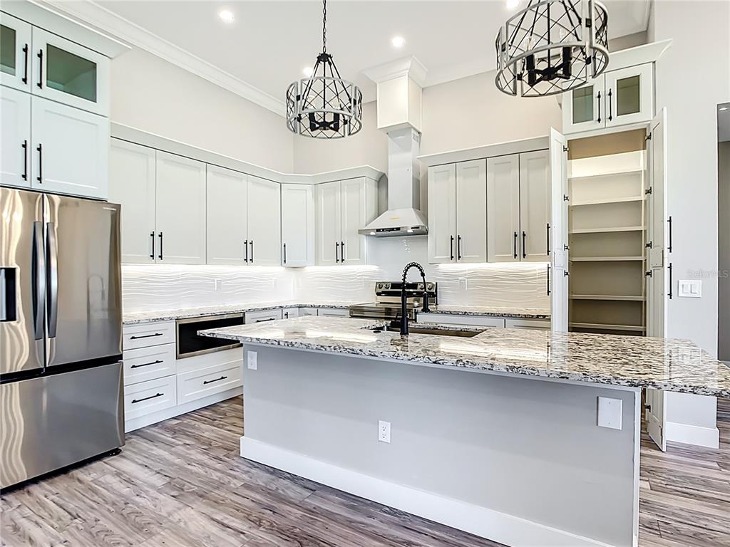 10588 Kidron Avenue Englewood, FL 34224 - Photo 8 of 53 a kitchen with stainless steel appliances granite countertop a sink refrigerator and cabinets
