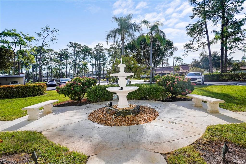 601 Augusta Boulevard, Unit 10 Naples, FL 34113 - Photo 22 of 27 View of property's community featuring a patio and a lawn
