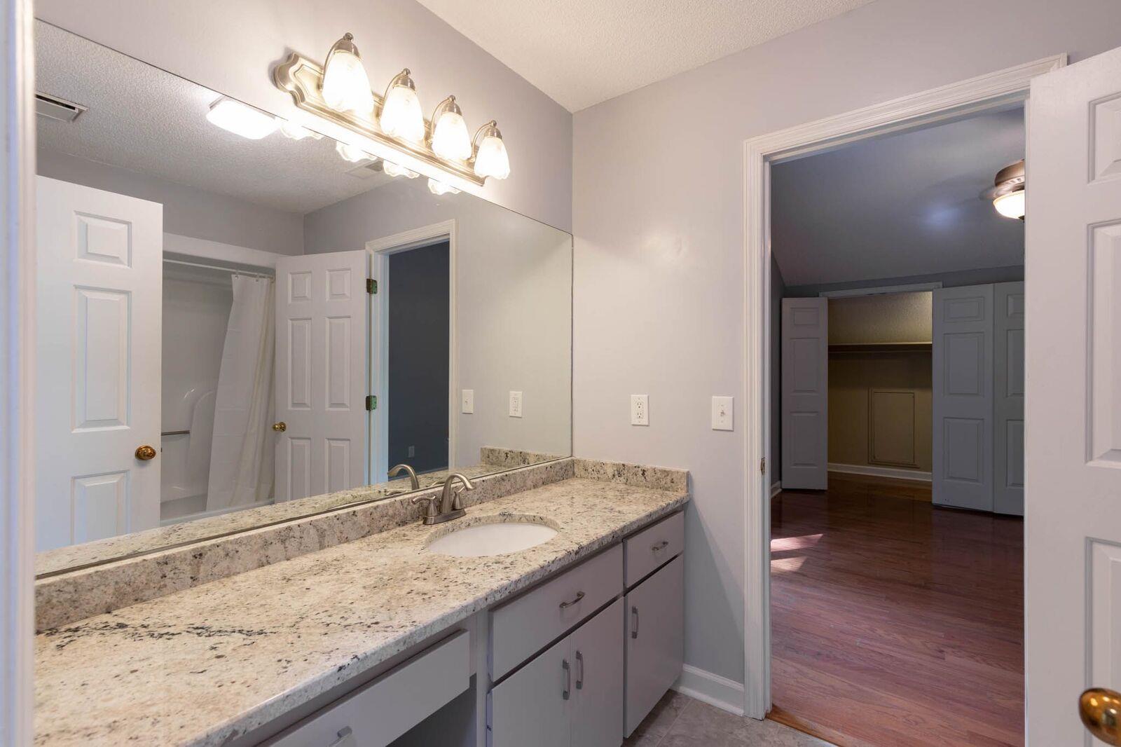 5831 Cane Ridge Road Antioch, TN 37013 - Photo 22 of 30 a bathroom with a granite countertop sink and a mirror
