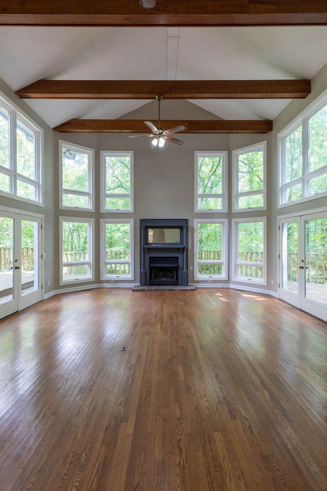 5831 Cane Ridge Road Antioch, TN 37013 - Photo 6 of 30 an empty room with fireplace wooden floor and windows