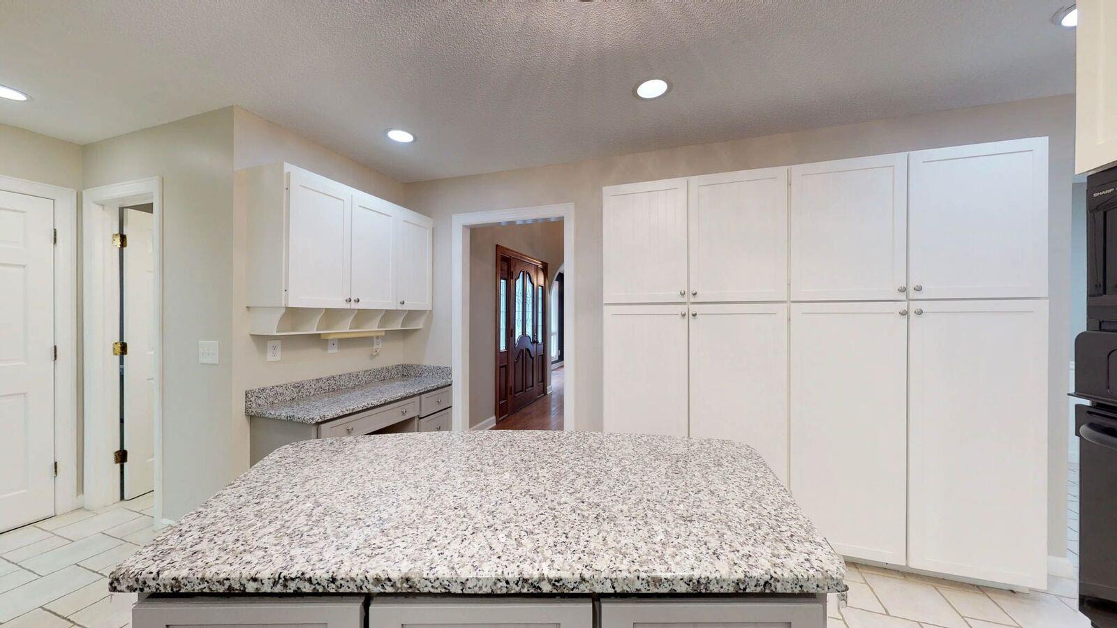 5831 Cane Ridge Road Antioch, TN 37013 - Photo 8 of 30 a view of a kitchen with kitchen island sink and refrigerator