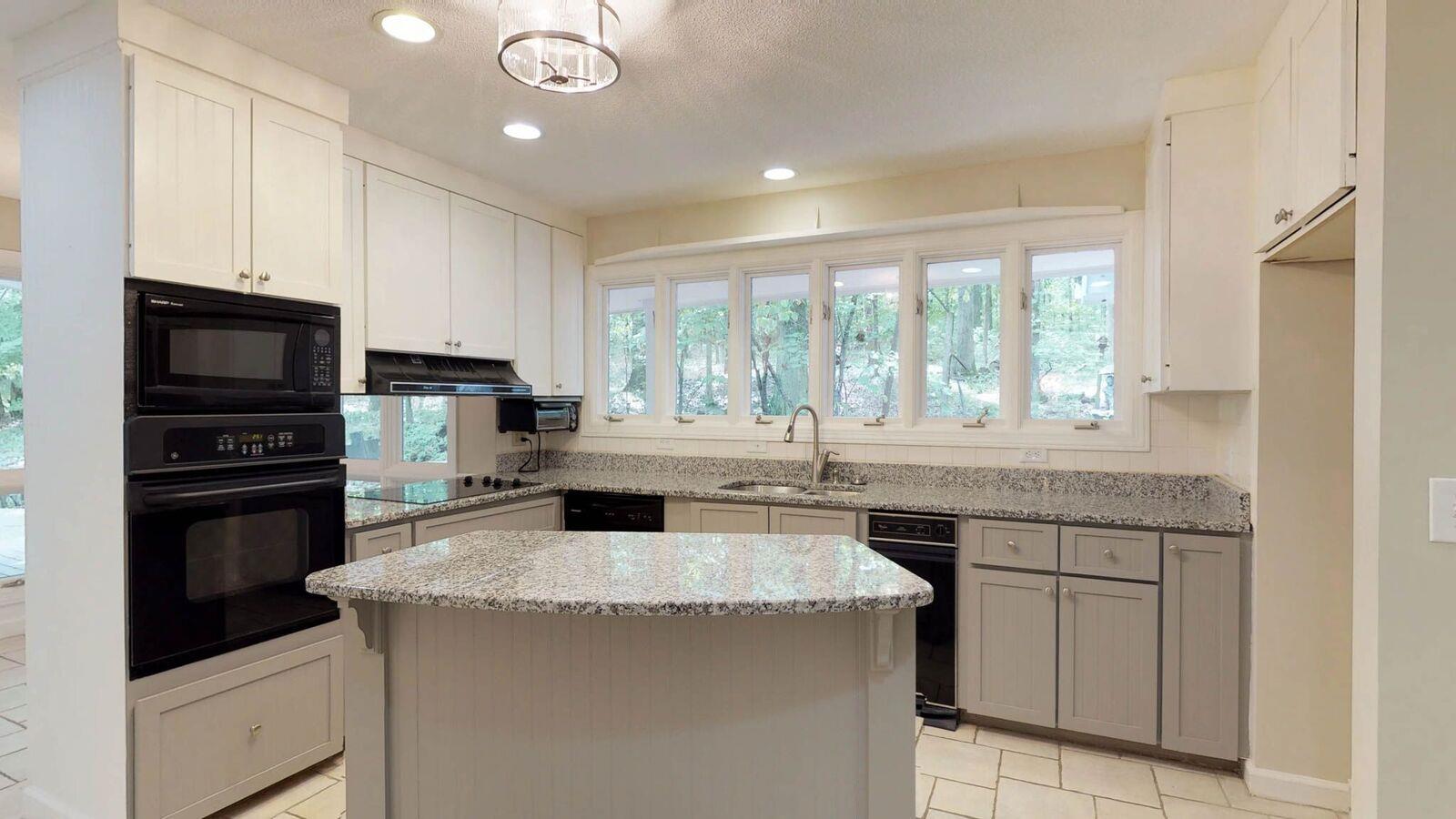 5831 Cane Ridge Road Antioch, TN 37013 - Photo 9 of 30 a kitchen with a sink stove and microwave
