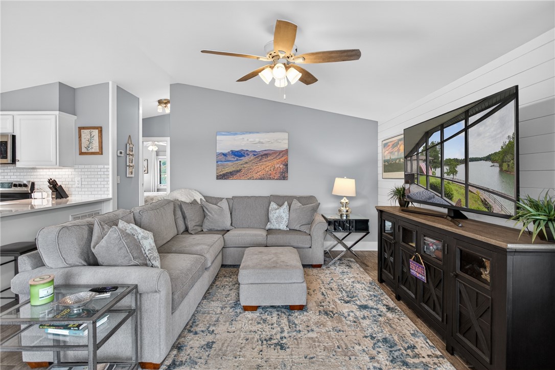 1230 Melton Road, Unit 4 West Union, SC 29696 - Photo 43 of 48 An open-concept living space with vaulted ceilings and a ceiling fan, seamlessly connecting to the kitchen area.