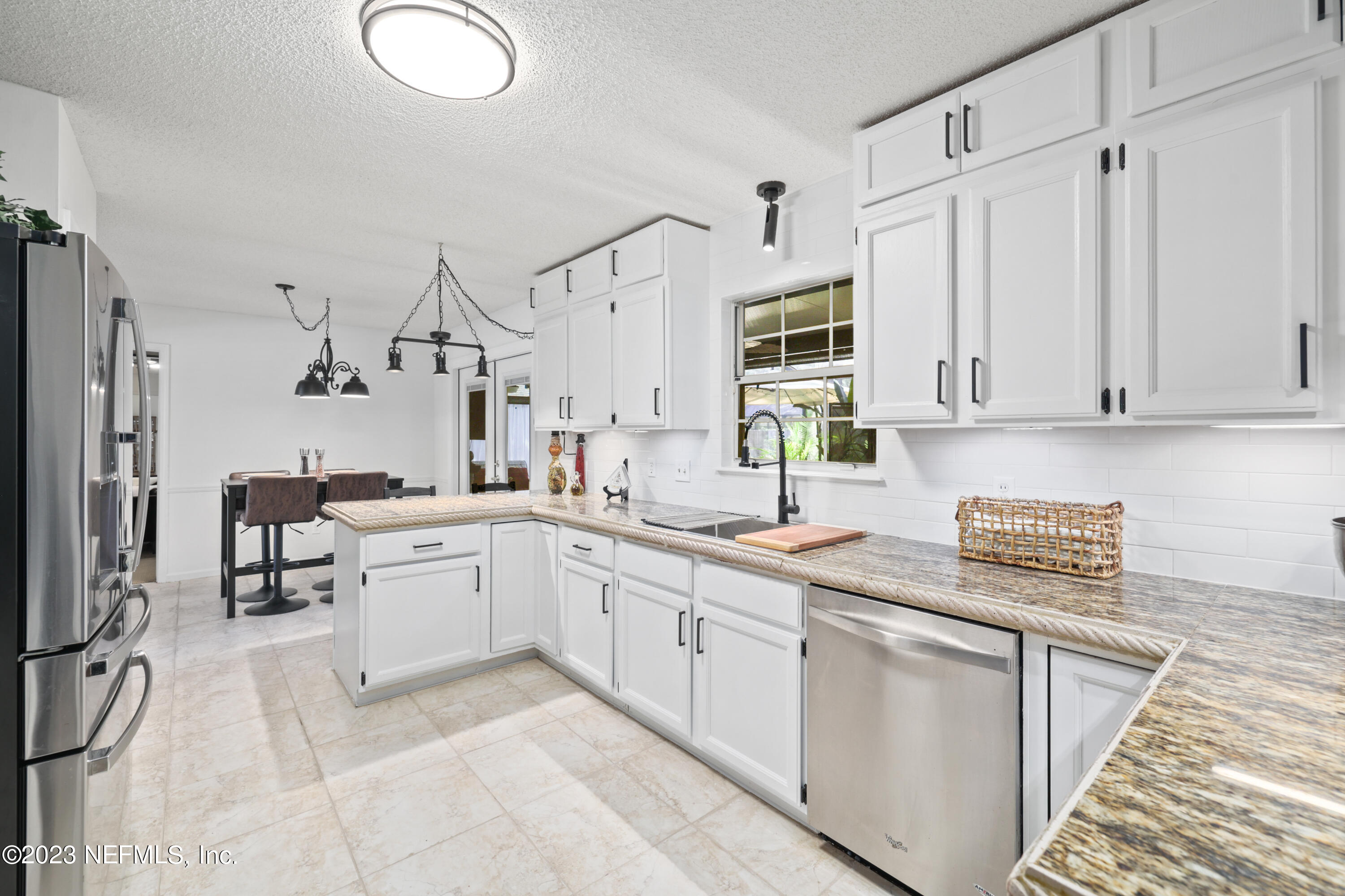 a kitchen with appliances cabinets and a sink