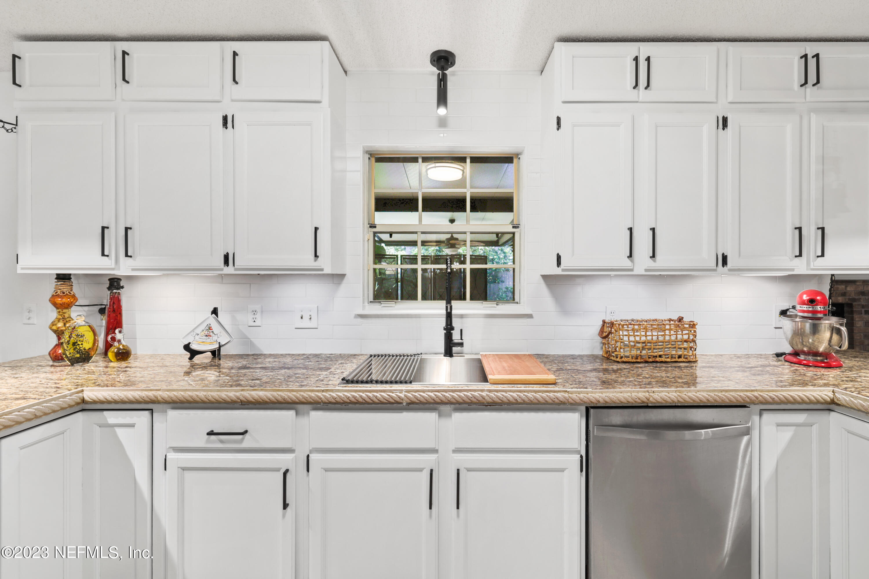 10954 Heathfield Road Jacksonville, FL 32225 - Photo 12 of 42 a kitchen with stainless steel appliances granite countertop a sink dishwasher and white cabinets