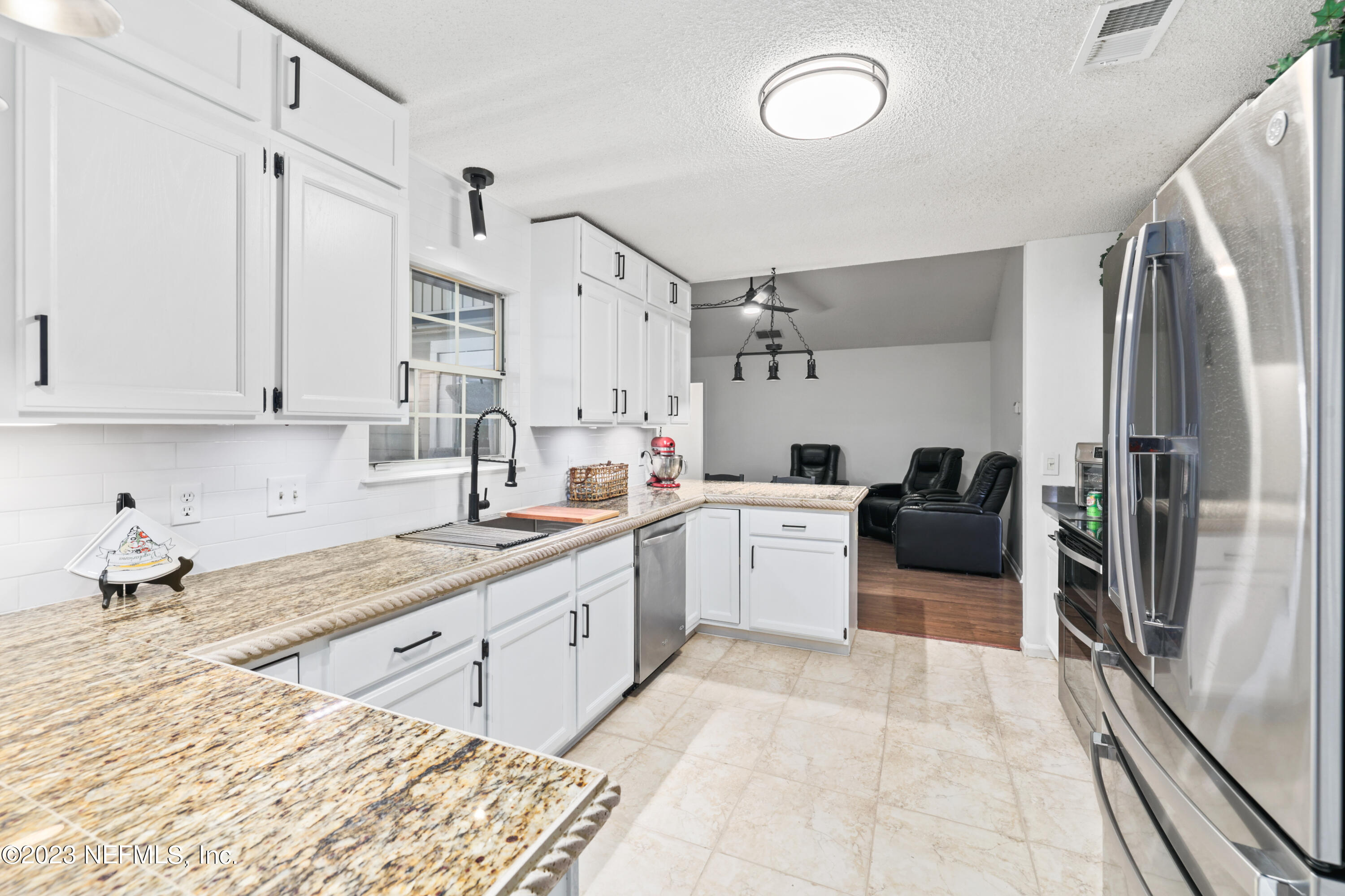 10954 Heathfield Road Jacksonville, FL 32225 - Photo 15 of 42 a kitchen with a sink stove and cabinets