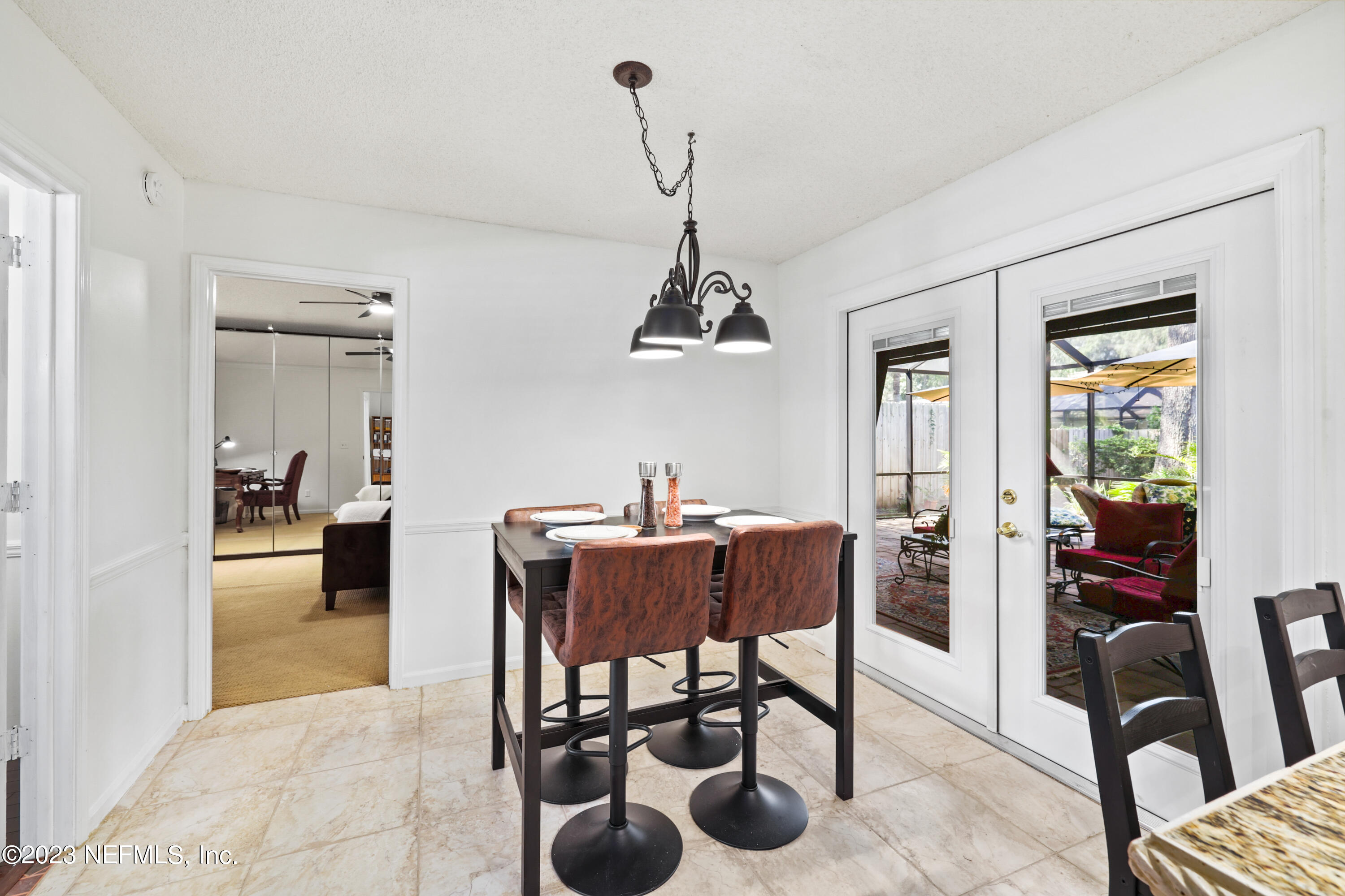 10954 Heathfield Road Jacksonville, FL 32225 - Photo 17 of 42 a view of a dining room with furniture and chandelier