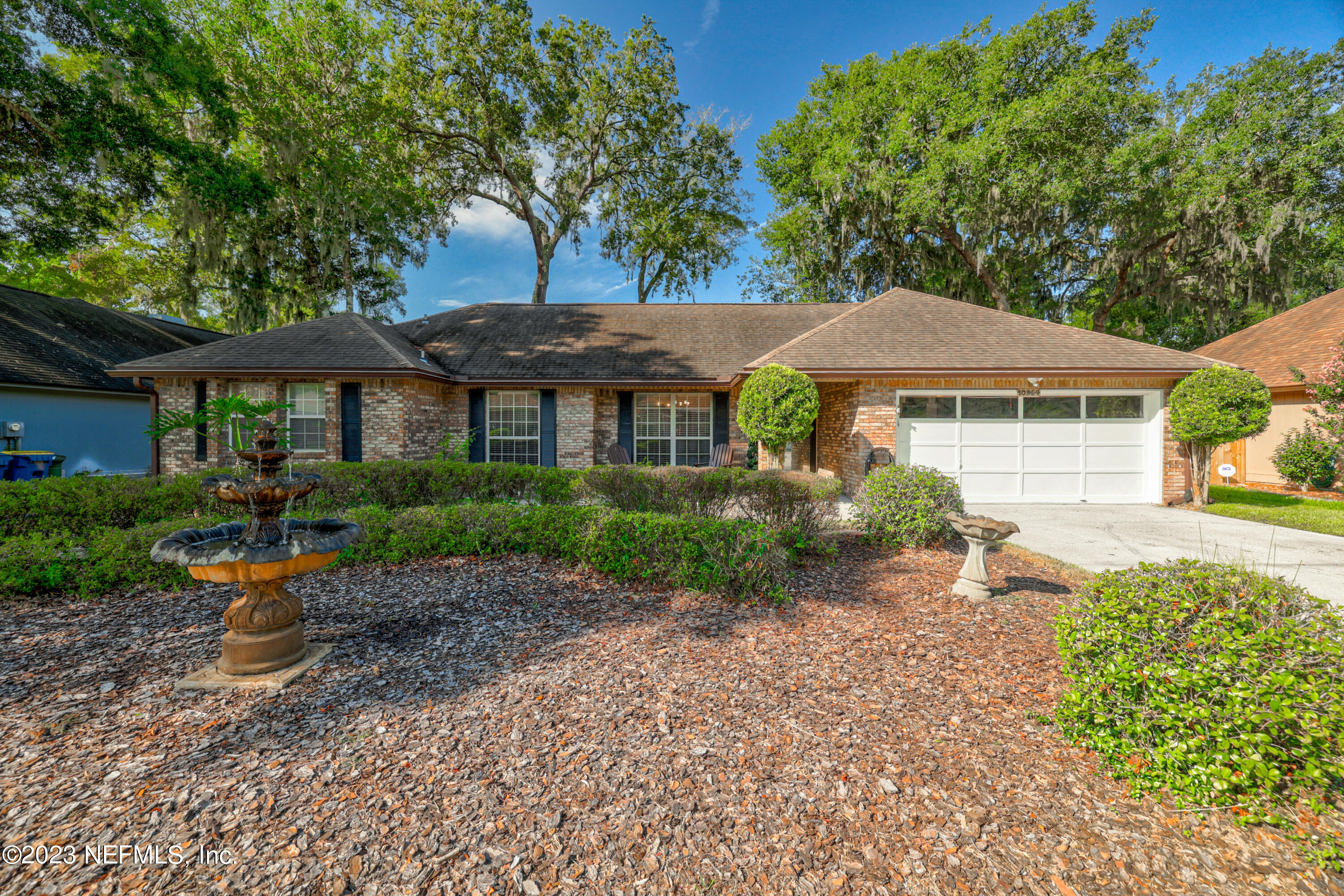 10954 Heathfield Road Jacksonville, FL 32225 - Photo 2 of 42 a front view of a house with a yard