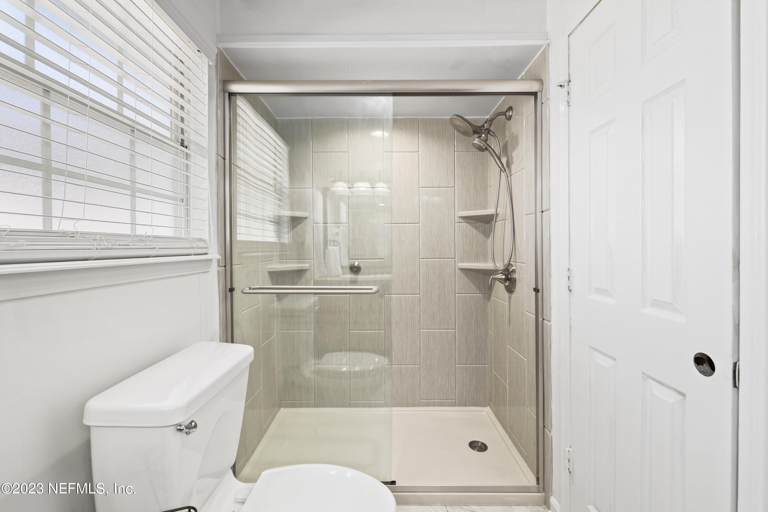 10954 Heathfield Road Jacksonville, FL 32225 - Photo 25 of 42 a bathroom with a shower a toilet and a shower