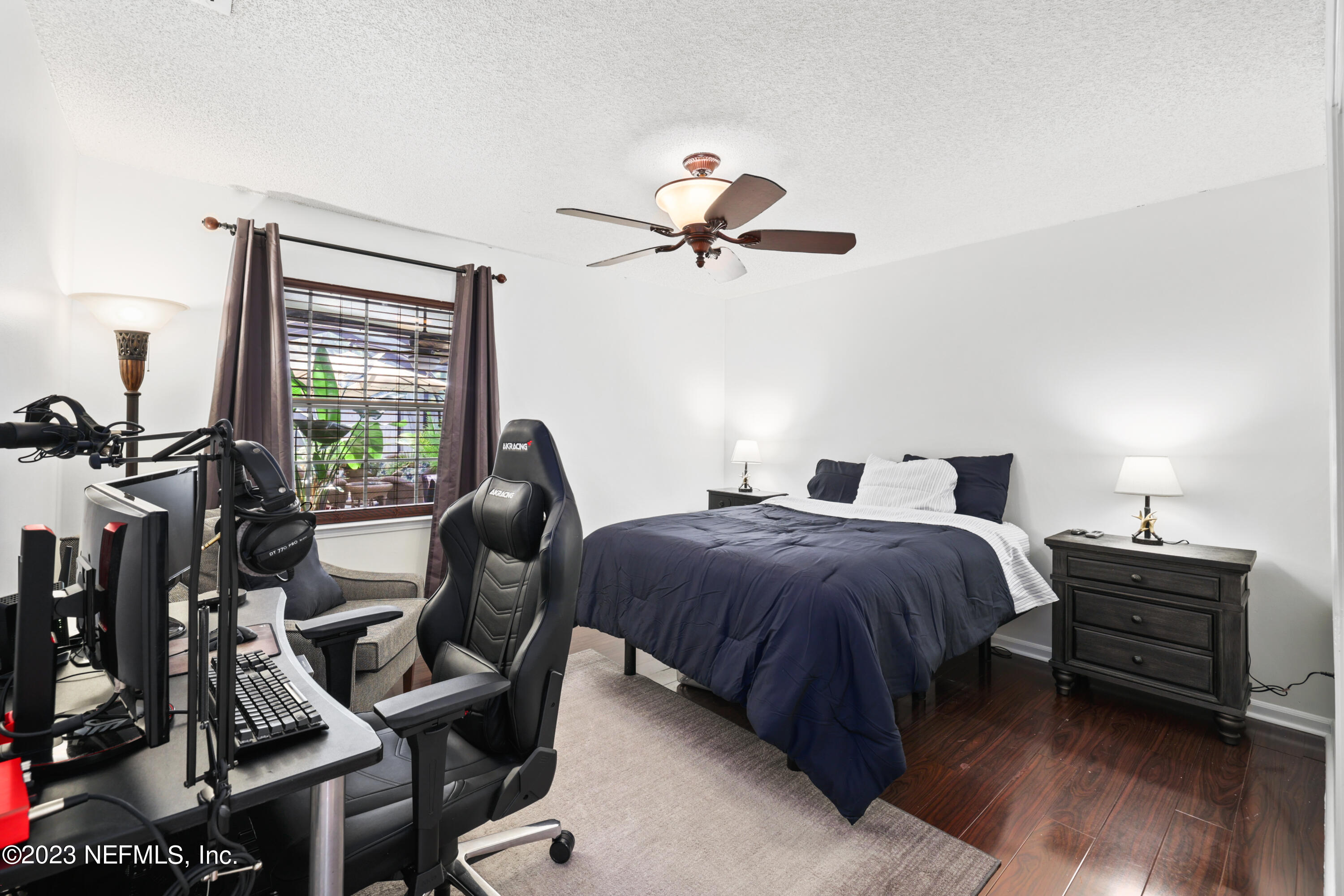 10954 Heathfield Road Jacksonville, FL 32225 - Photo 26 of 42 a bedroom with a bed and a chandelier