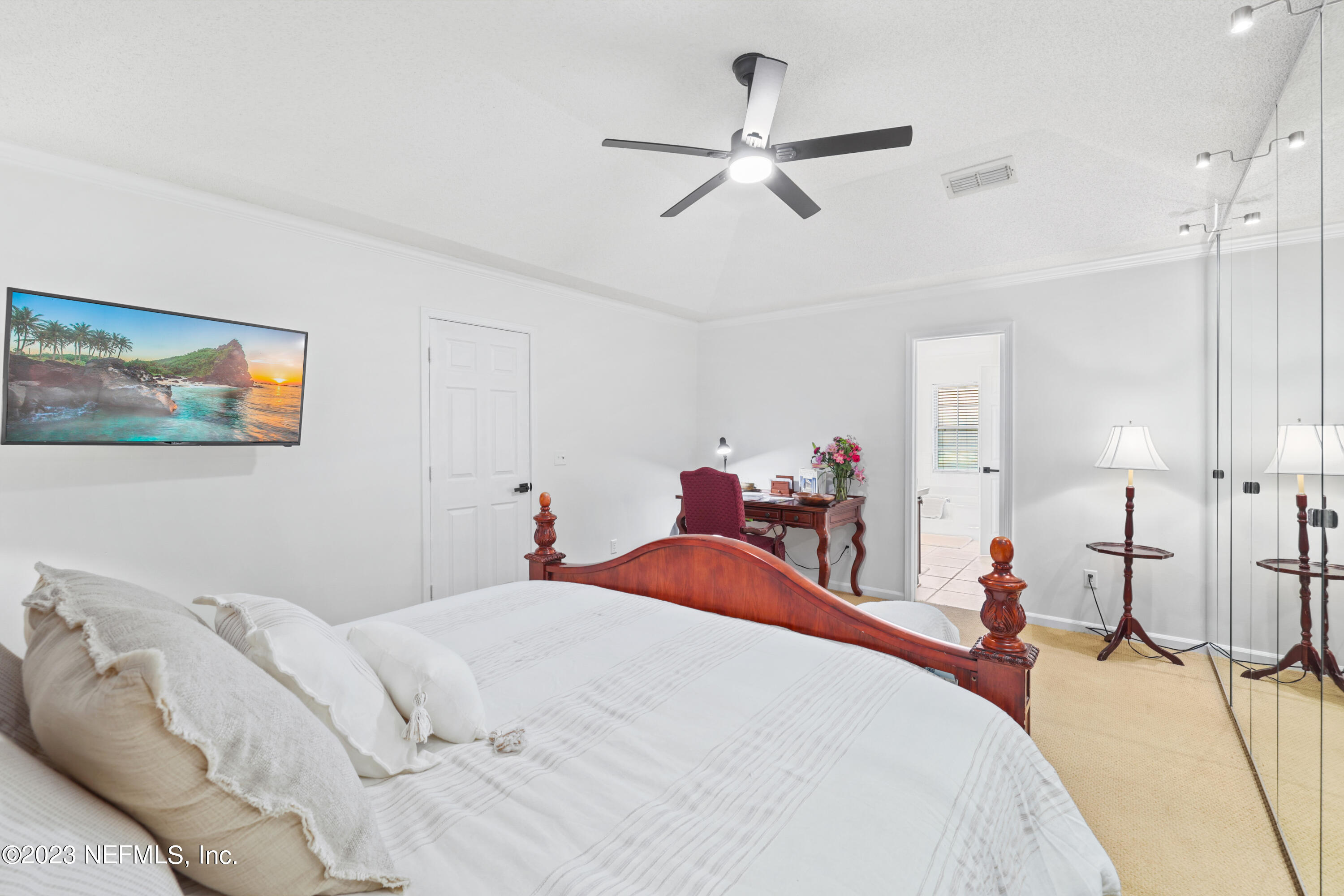 10954 Heathfield Road Jacksonville, FL 32225 - Photo 29 of 42 a bed room with a bed and a chandelier