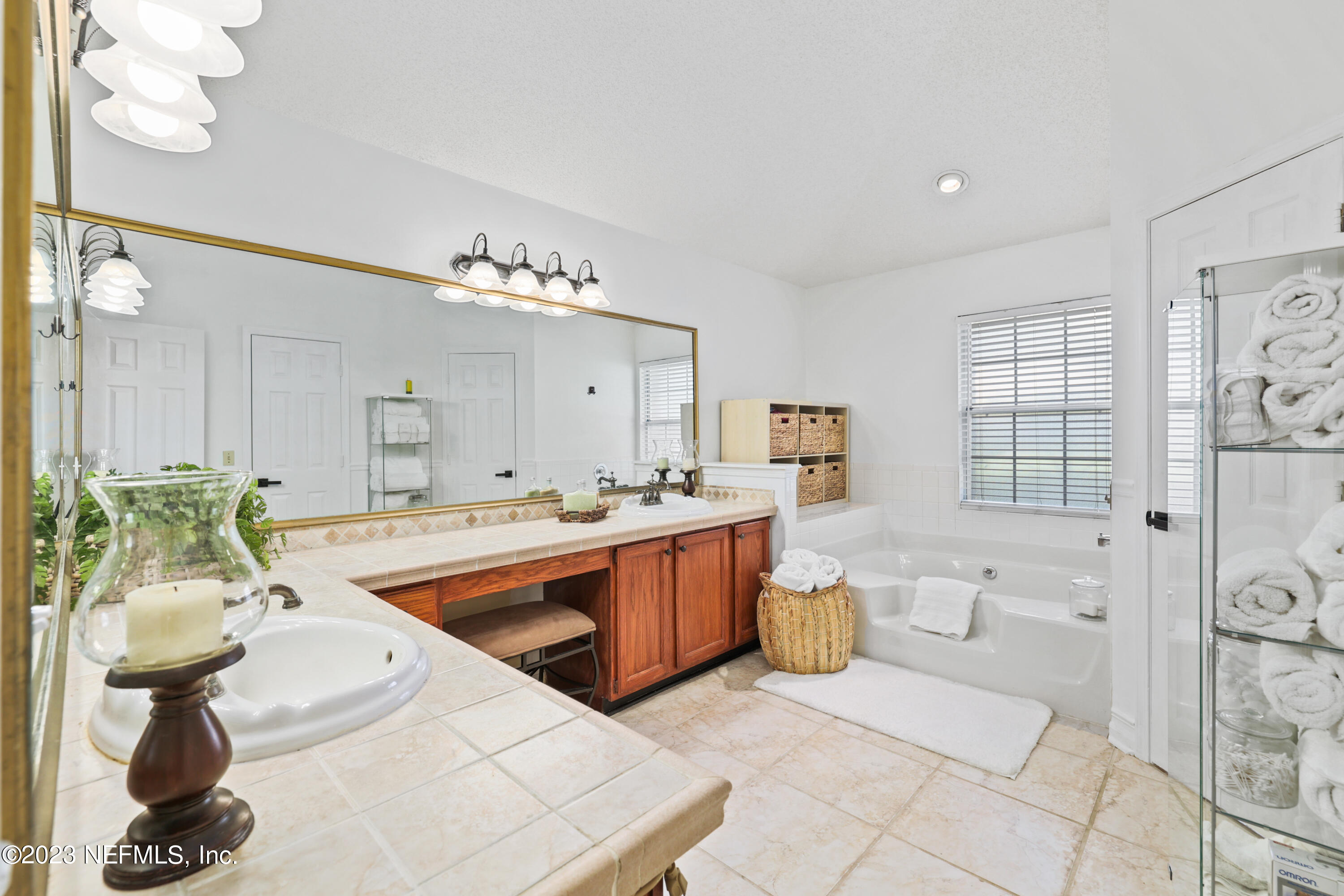10954 Heathfield Road Jacksonville, FL 32225 - Photo 30 of 42 a large white kitchen with a sink and wooden floor