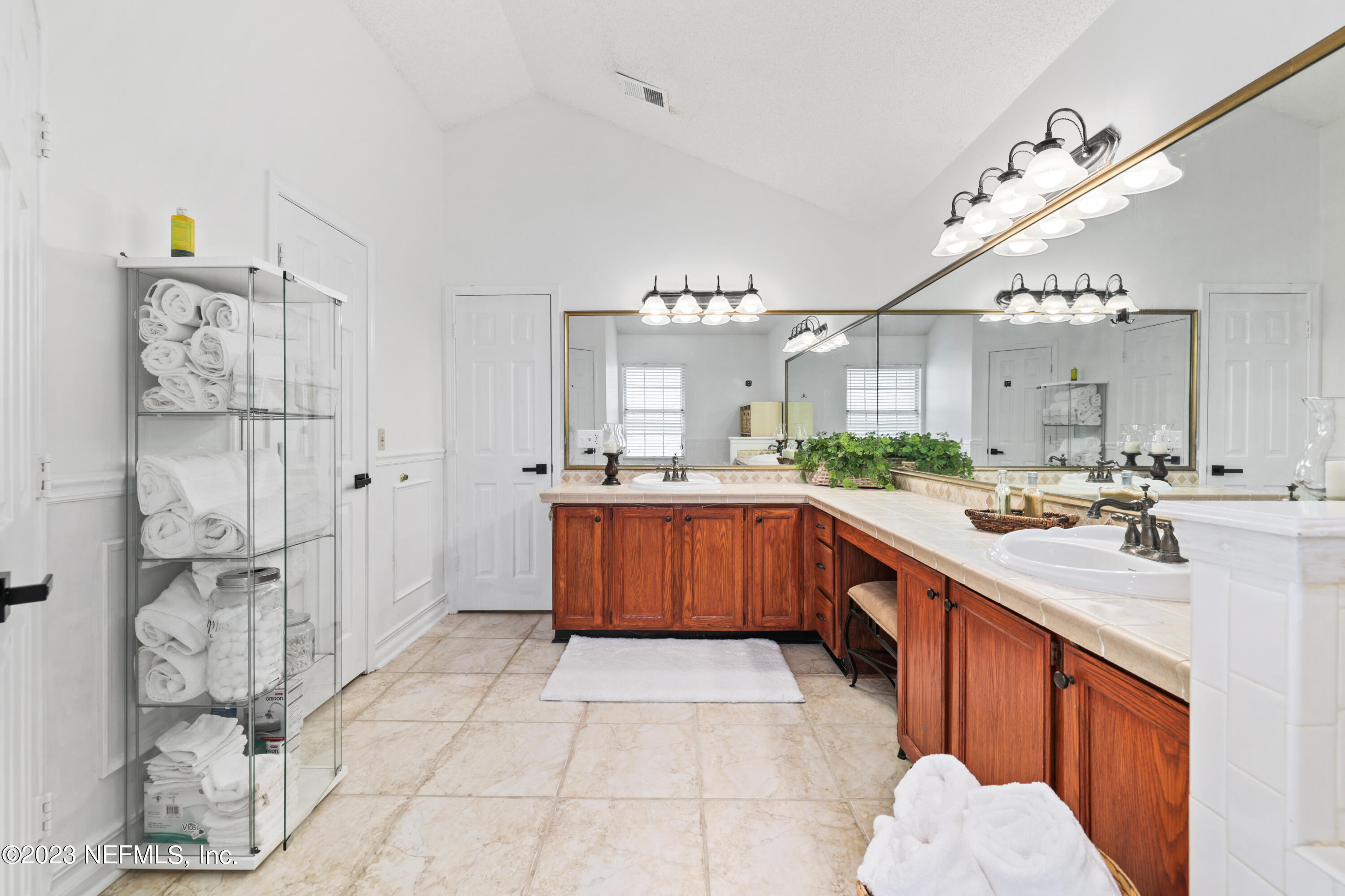 10954 Heathfield Road Jacksonville, FL 32225 - Photo 32 of 42 a large kitchen with kitchen island a sink stainless steel appliances and cabinets