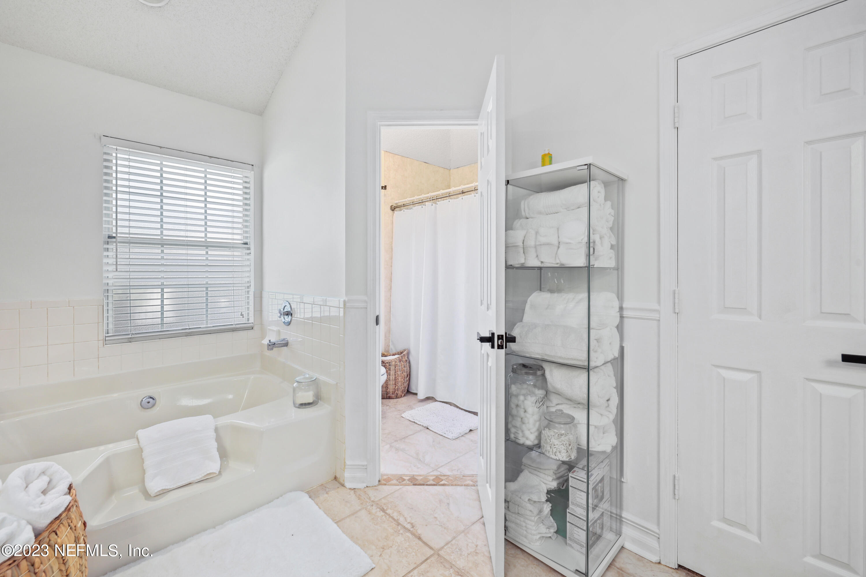 10954 Heathfield Road Jacksonville, FL 32225 - Photo 33 of 42 a bathroom with a bathtub and shower