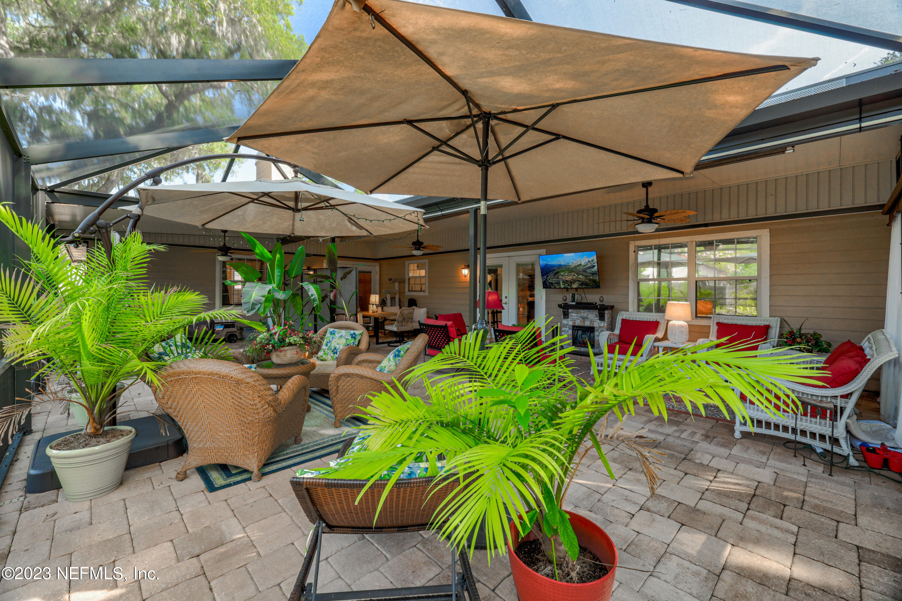 10954 Heathfield Road Jacksonville, FL 32225 - Photo 36 of 42 a view of a chairs and table under an umbrella in the patio
