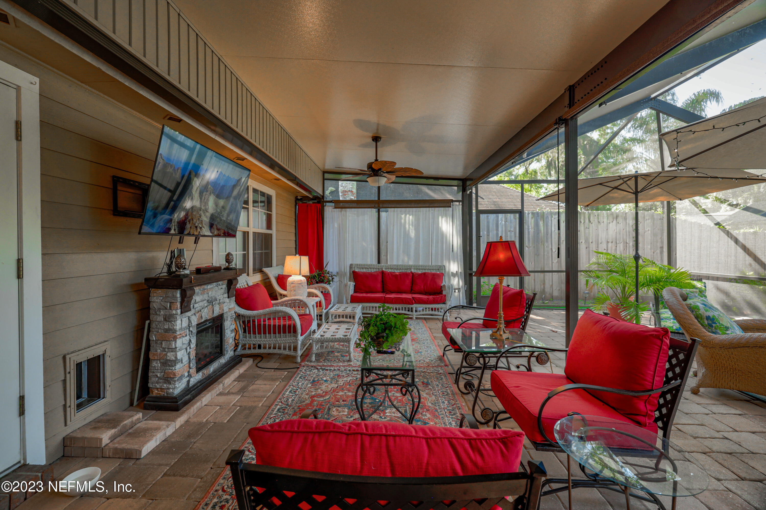 10954 Heathfield Road Jacksonville, FL 32225 - Photo 38 of 42 a living room filled with lots of furniture and a chandelier