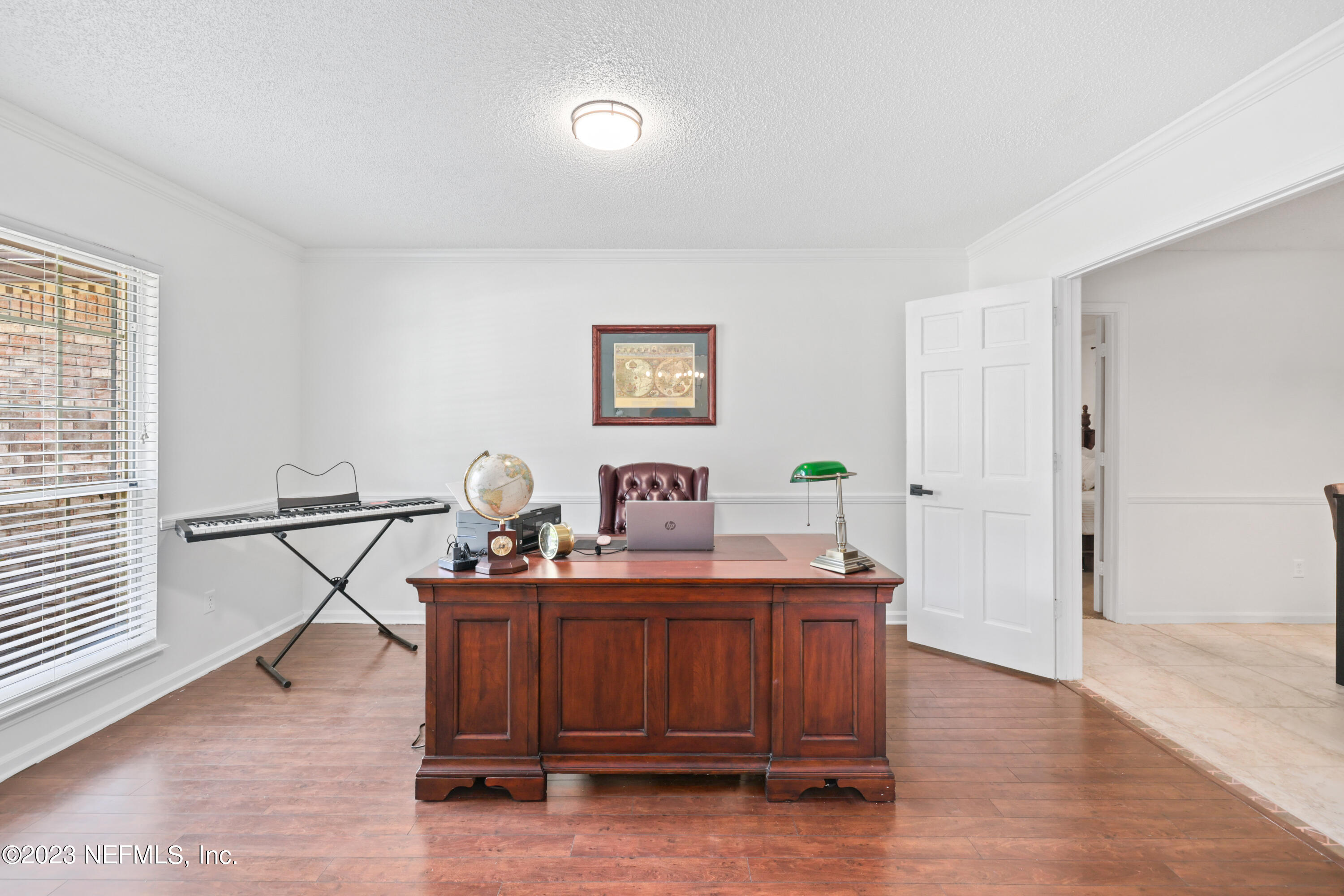 10954 Heathfield Road Jacksonville, FL 32225 - Photo 8 of 42 a view of a workspace with furniture and wooden floor