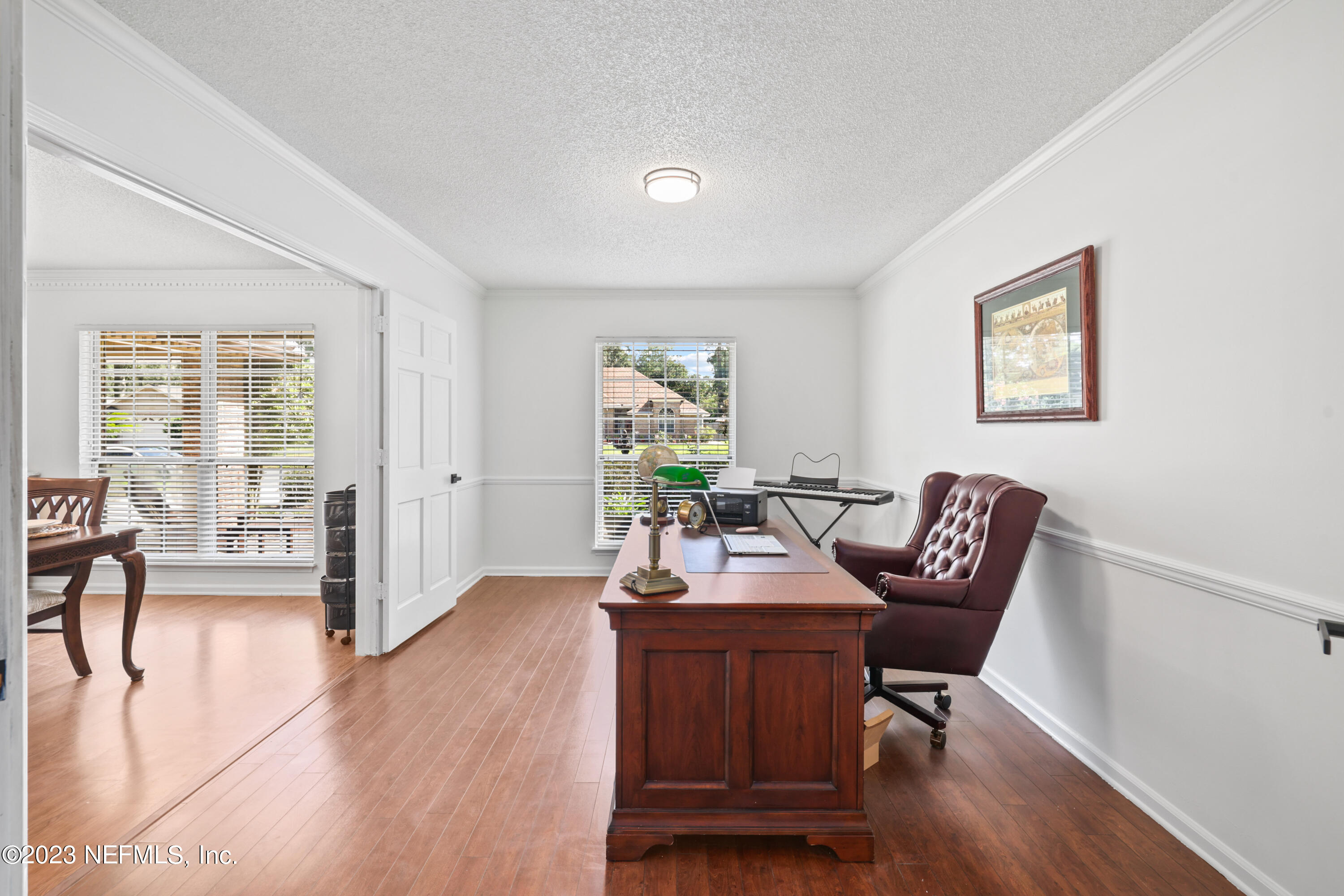 10954 Heathfield Road Jacksonville, FL 32225 - Photo 9 of 42 a workspace with furniture and wooden floor